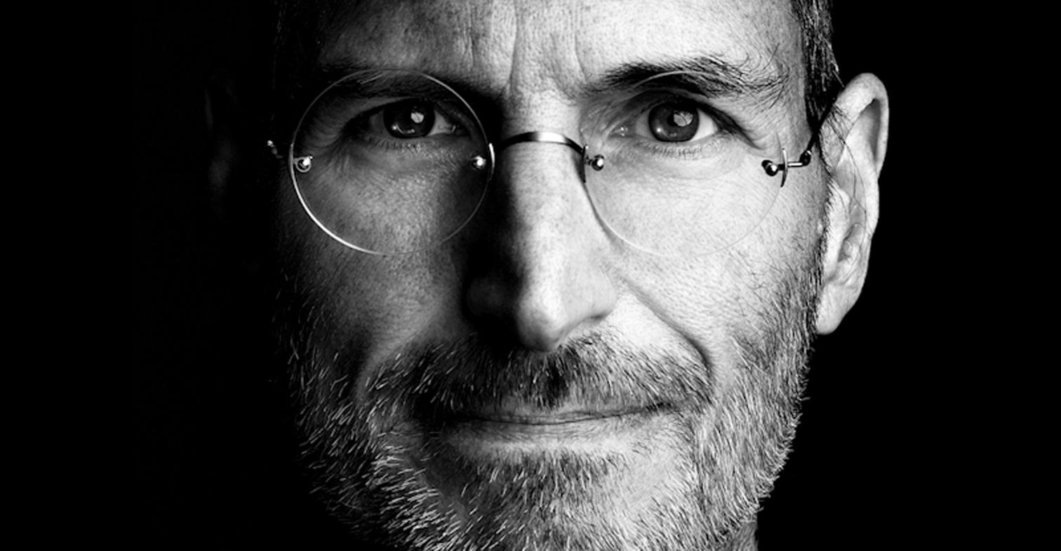 Black and white close-up of Steve Jobs in rimless glasses